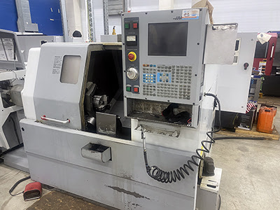 Haas SL-10HE (2003 | бу) с ЧПУ – токарный станок с прутковым податчиком